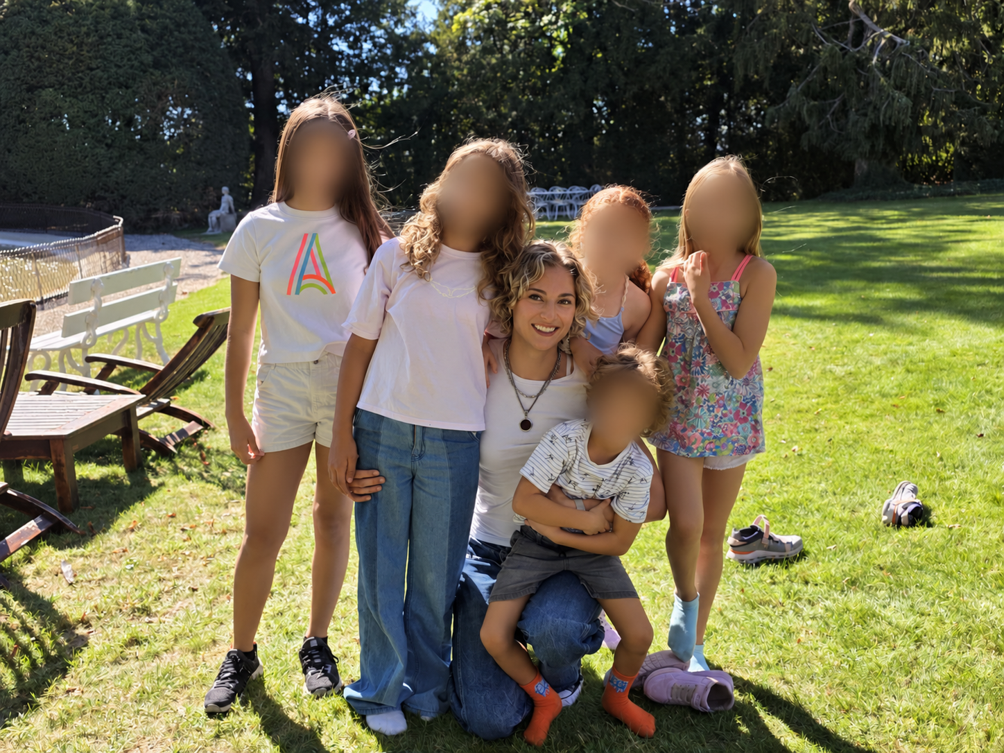Cast gathered together in a sunlit garden